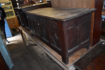 Lot 1150 - An 18th century oak coffer with carved panel...