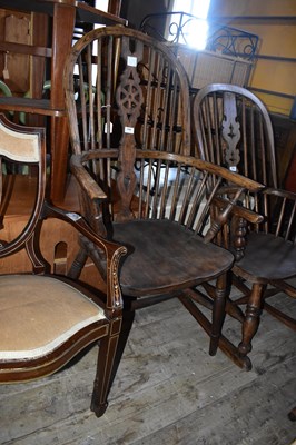 Lot 1185 - A 19th century elm seated Windsor elbow chair.