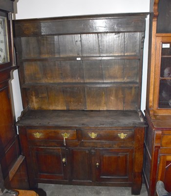 Lot 1192 - An 18th century oak dresser, the boarded plate...