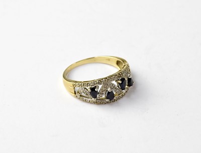 Lot 1065 - A modern sapphire and diamond ring