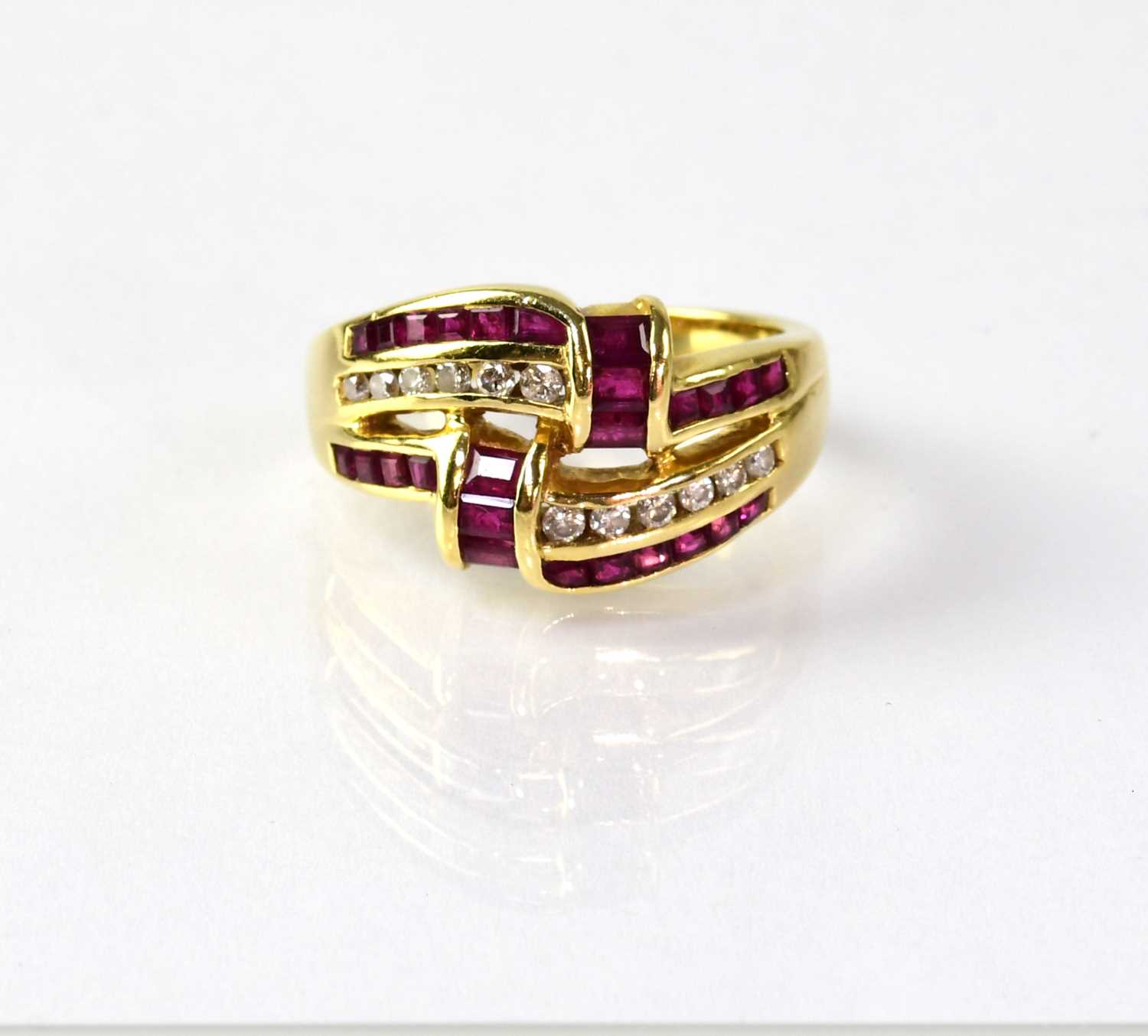 Lot 835 - An 18ct gold ring set with rubies and diamonds,...