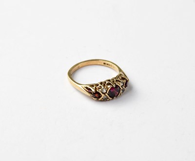 Lot 1047 - A 9ct rose gold red and white stone ring