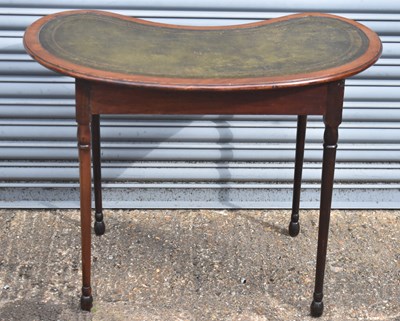 Lot 61 - A mahogany kidney shaped side table with green...