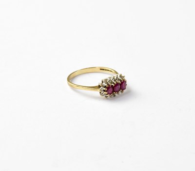 Lot 1057 - A vintage 9ct gold ruby and diamond cluster ring