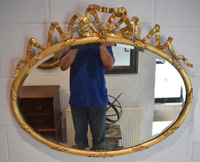 Lot 18 - A late 19th century decorative gilt oval wall...