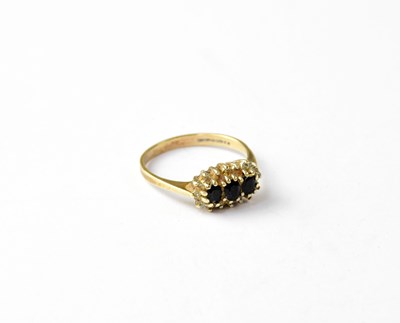 Lot 1038 - A 9ct gold sapphire and white stone cluster ring
