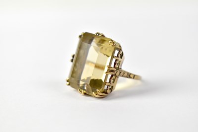 Lot 1042 - A 9ct gold tinted quartz dress ring