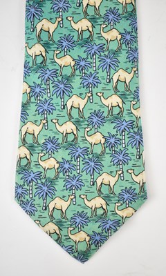 Lot 437 - HERMES; a 100% silk green tie with camel design.