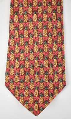 Lot 439 - HERMES; a 100% silk red tie with pineapple...