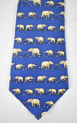 Lot 440 - HERMES; a 100% silk blue tie with elephant...