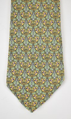 Lot 442 - HERMES; a 100% silk green tie with yellow...