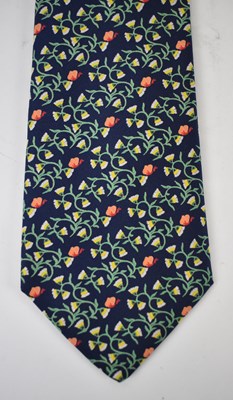 Lot 444 - HERMES; a 100% silk blue tie with orange and...