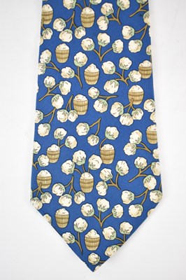 Lot 447 - HERMES; a 100% silk blue tie with cotton plant...