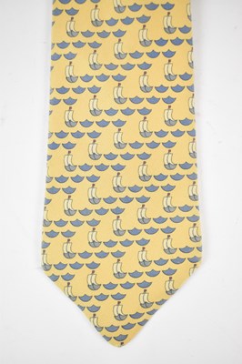 Lot 449 - HERMES; a 100% silk yellow tie with sailing...