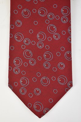 Lot 452 - HERMES; a 100% silk red tie with geometric...