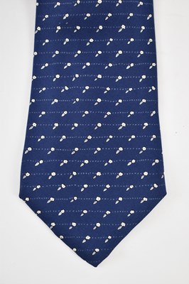 Lot 456 - HERMES; a 100% silk blue tie with white flower...