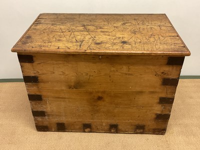 Lot 773 - A large pine chest with metal bound edges,...