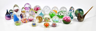 Lot 386 - A collection of thirty-two glass paperweights,...