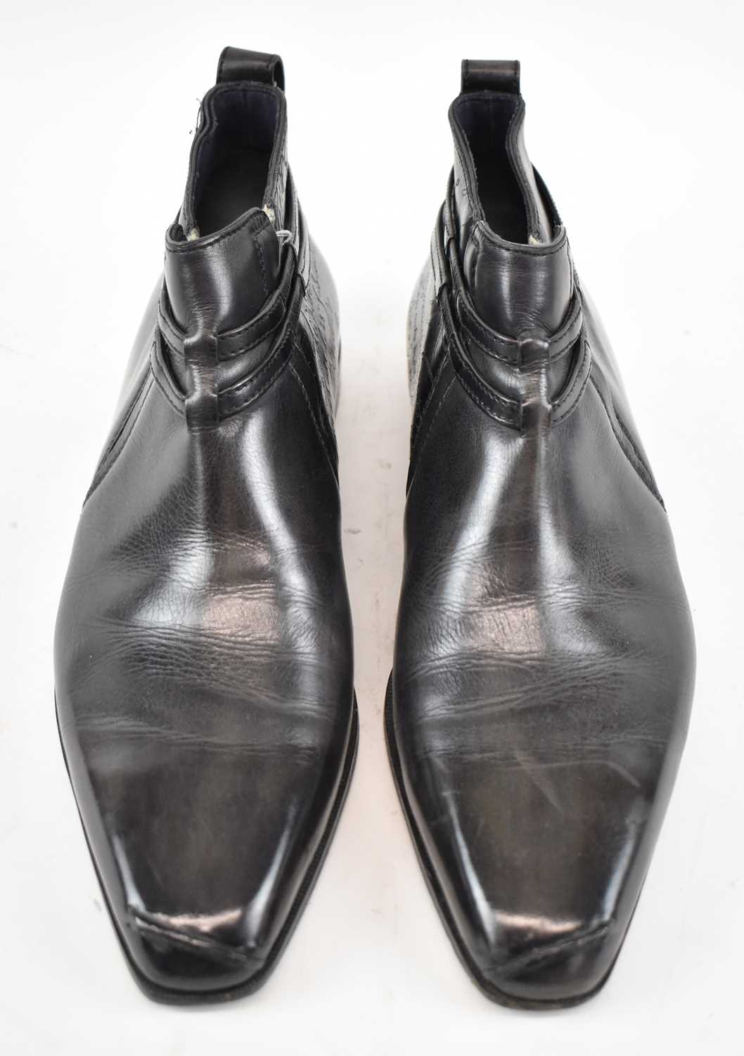 Lot 550 - BERLUTI; a pair of black leather ankle boots,...