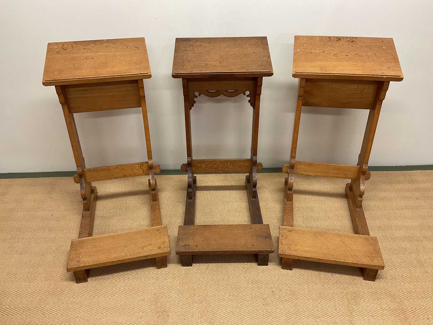 Lot 757 - Three oak church kneelers, height 83cm.