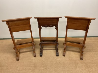 Lot 757 - Three oak church kneelers, height 83cm.