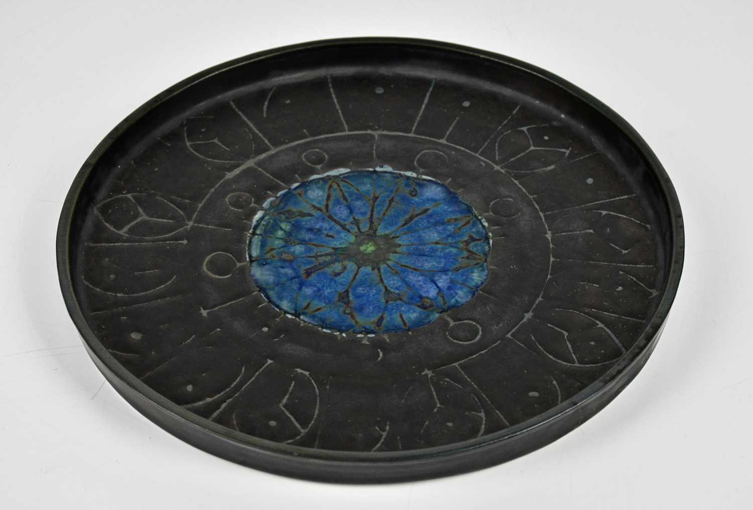 Lot 33 - TROIKA POTTERY; a circular wall charger with...