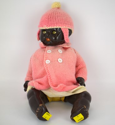 Lot 466 - An early 20th century black doll with...