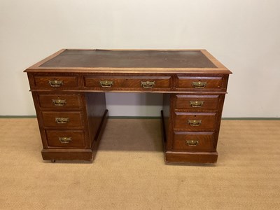 Lot 810 - An early 20th century oak twin pedestal knee...