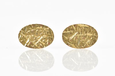 Lot 692 - A pair of 9ct textured yellow gold cufflinks,...