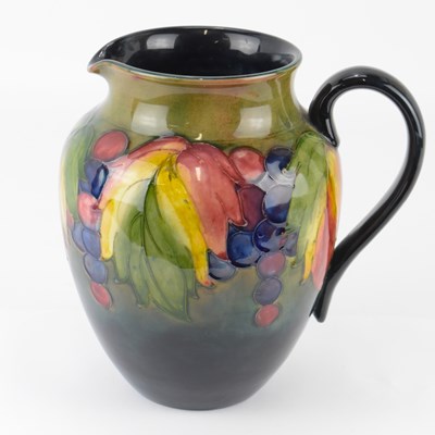 Lot 248 - WILLIAM MOORCROFT; a tall jug with tube-lined...