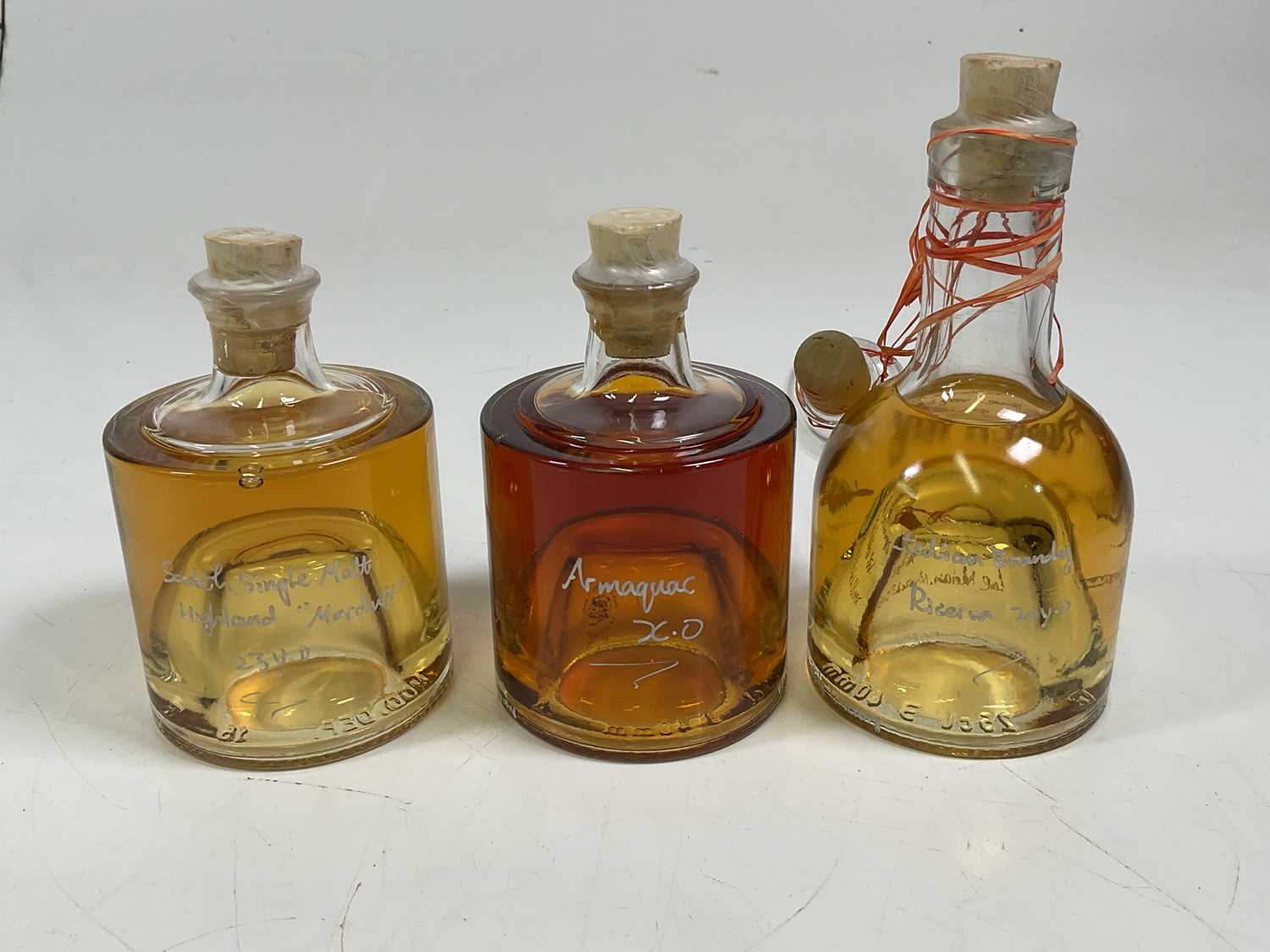 Lot 275 - Three bottles of Italian brandy, single malt...