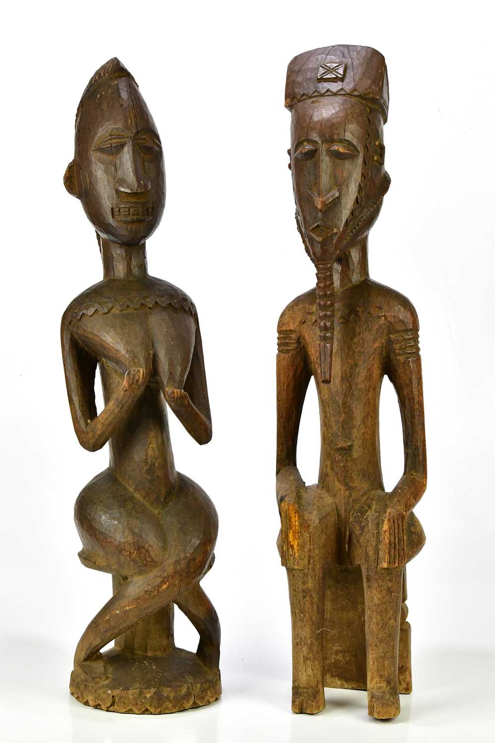 Lot 1223 - Two hardwood carved African figures of male...