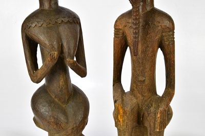 Lot 1223 - Two hardwood carved African figures of male...