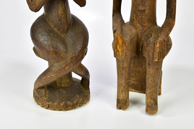 Lot 1223 - Two hardwood carved African figures of male...