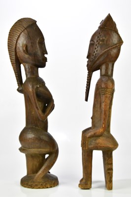 Lot 1223 - Two hardwood carved African figures of male...