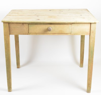 Lot 22 - A small rustic pine kitchen table with single...