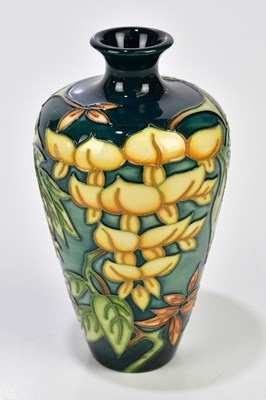 Lot 136 - MOORCROFT; a tapering cylindrical vase with...