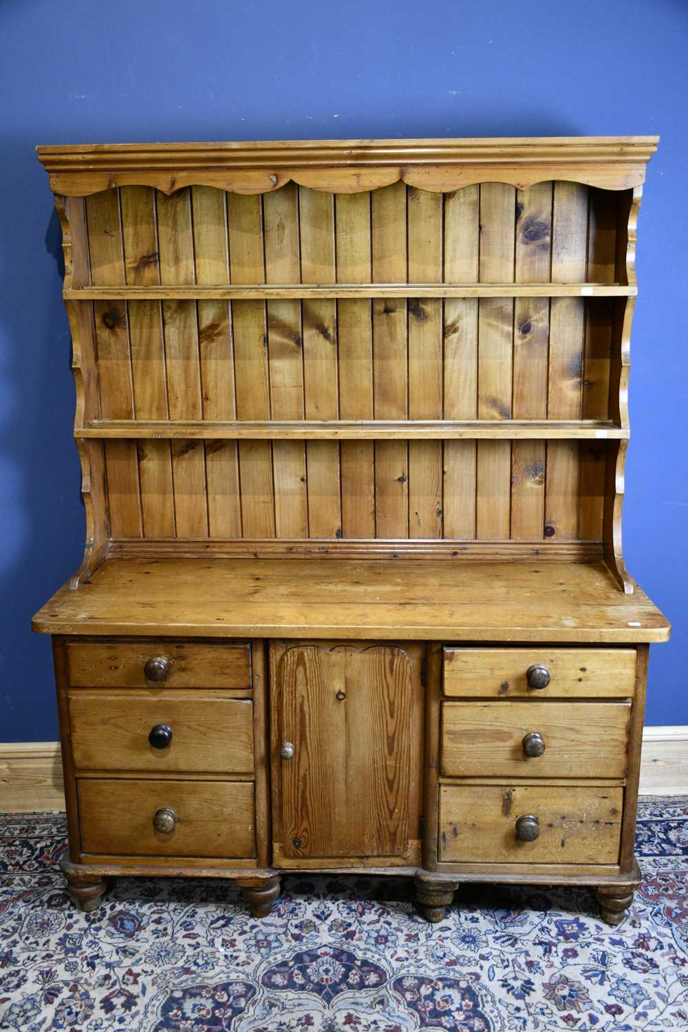 Lot 6566 - An old pine dresser with boarded plate rack...