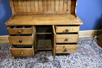 Lot 6566 - An old pine dresser with boarded plate rack...