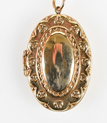 Lot 449 - A yellow metal pendant suspended on a yellow...