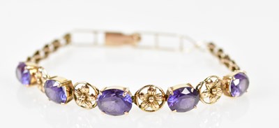 Lot 534 - A 9ct yellow gold bracelet with flower head...