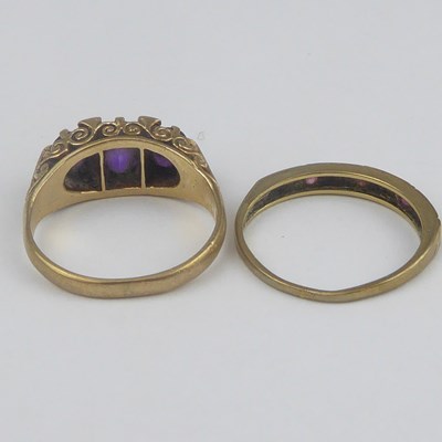 Lot 894 - Two 9ct gold dress rings, one with three...