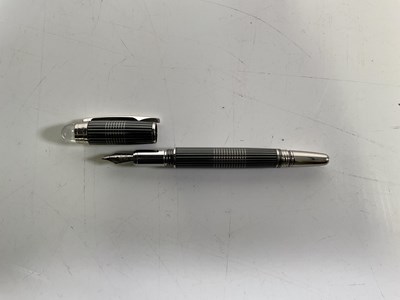 Lot 21 - A black and silver Montblanc fountain pen,...