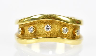 Lot 130 - An 18ct yellow gold shaped dress ring set with...