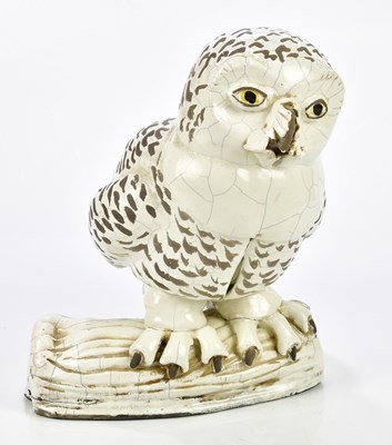 Lot 193 - A large raku model of an owl perching on a log,...