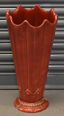 Lot 106 - An Art Nouveau style red glazed pottery stick...