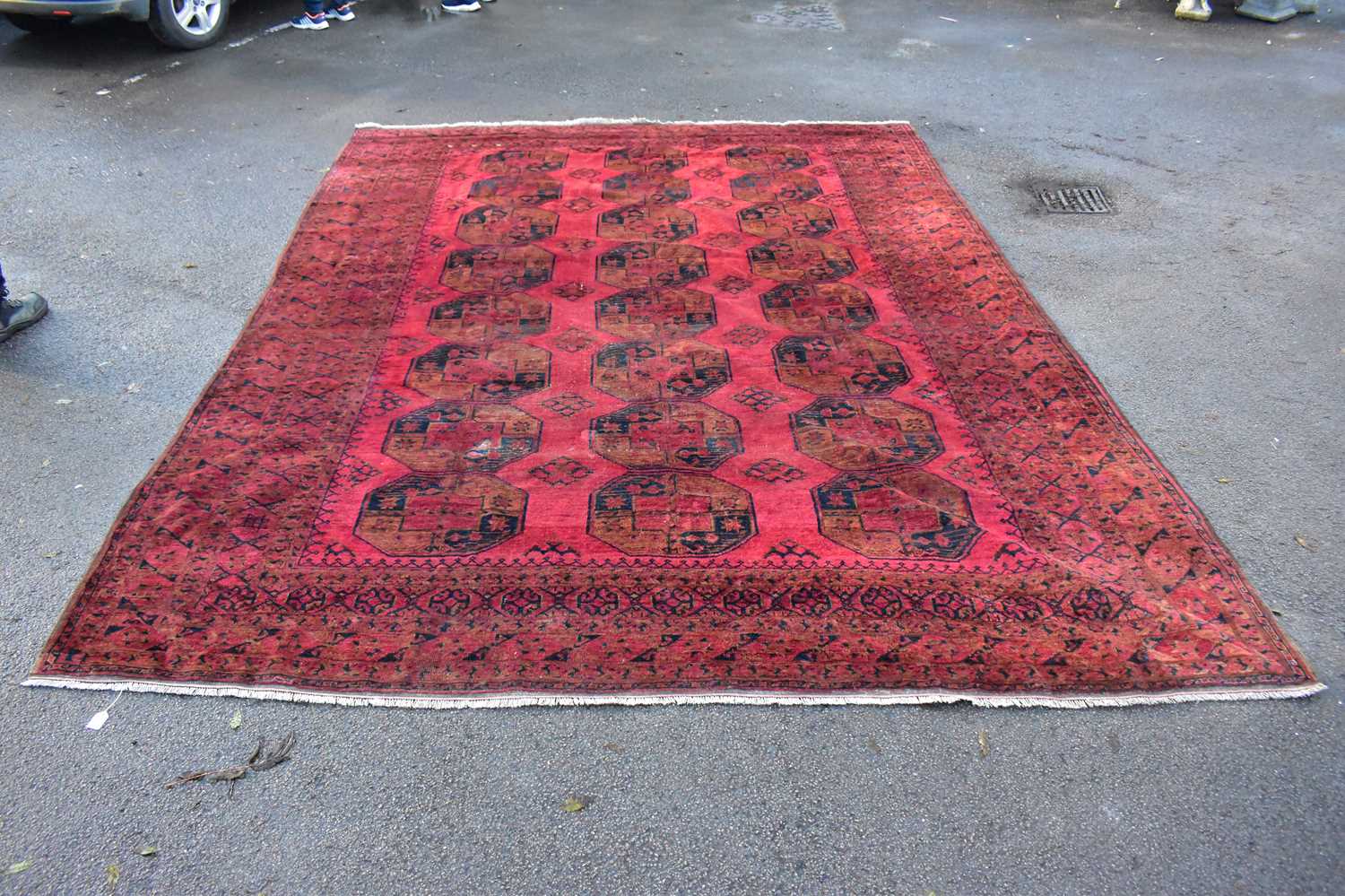 Lot 2283 - A large Eastern style red ground rug with