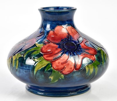 Lot 149 - MOORCROFT; a squat vase decorated in the...