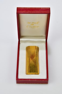 Lot 11 - CARTIER; a boxed Must de Cartier gold plated...