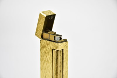 Lot 17 - DUNHILL; a gold plated textured rectangular...